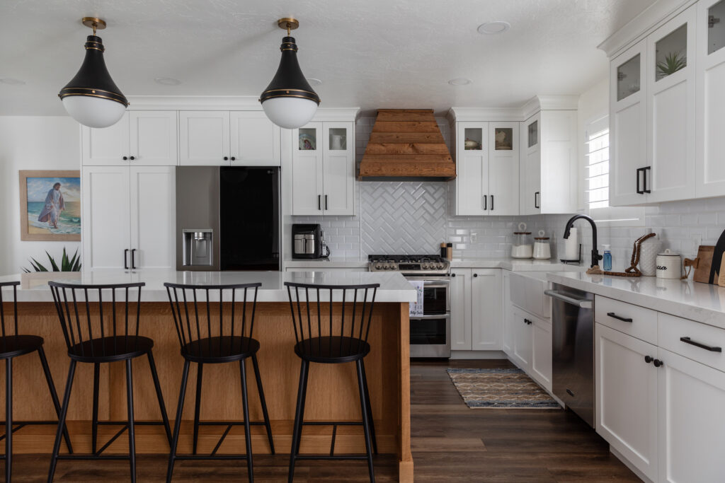 custom kitchen with two tone white perimeter cabinetry and white oak island, custom wood hood,lg refrigerator and signature kitchen suite dishwasher