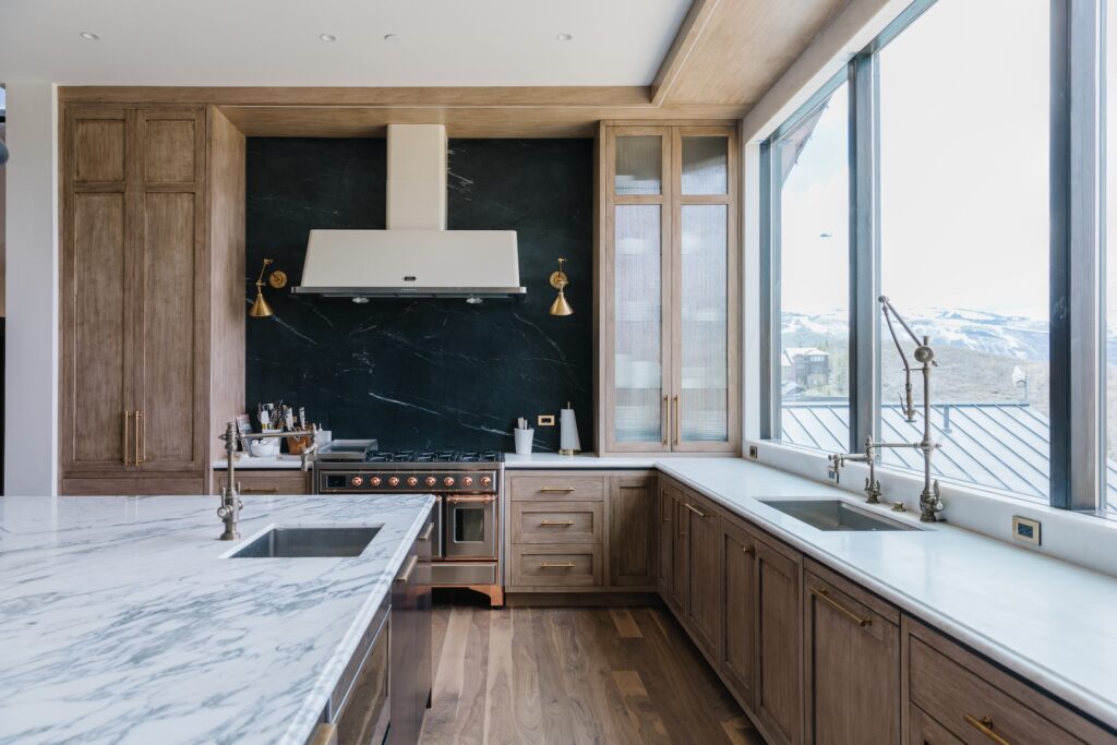 kitchen with wood custom cabinetry, ribbed glass fronts