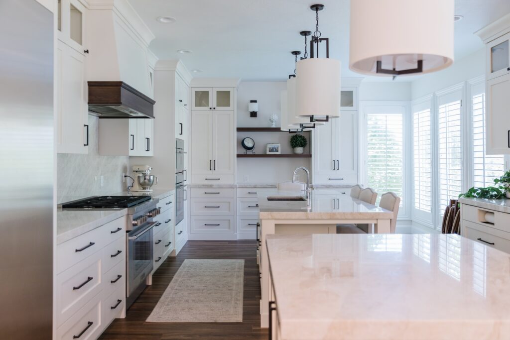 white kitchen with shaker custom cabinetry and double island